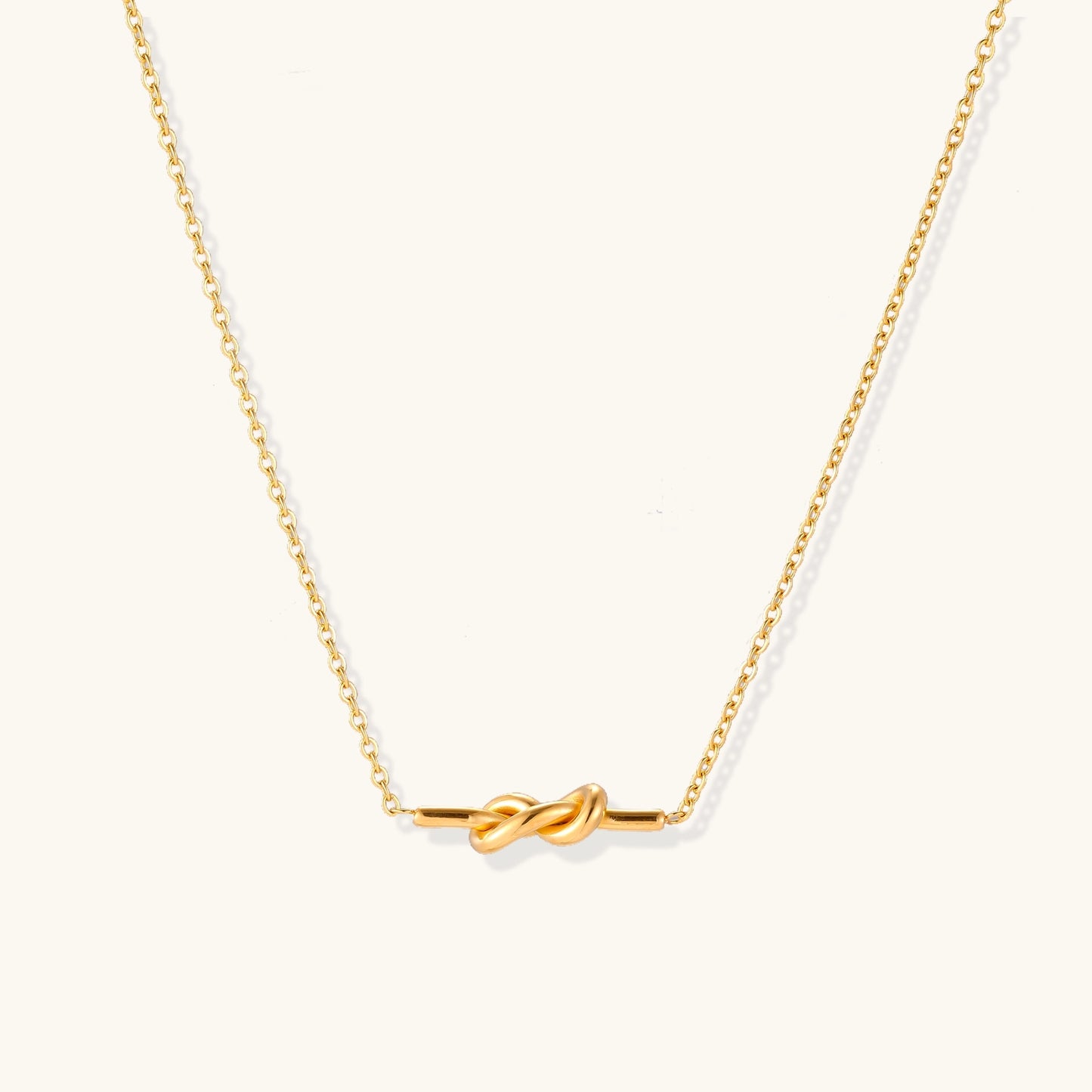 Dainty 18K gold plated necklace with infinity knot pendant on delicate chain against white background,  a perfect envouragement jewelry gift for women 