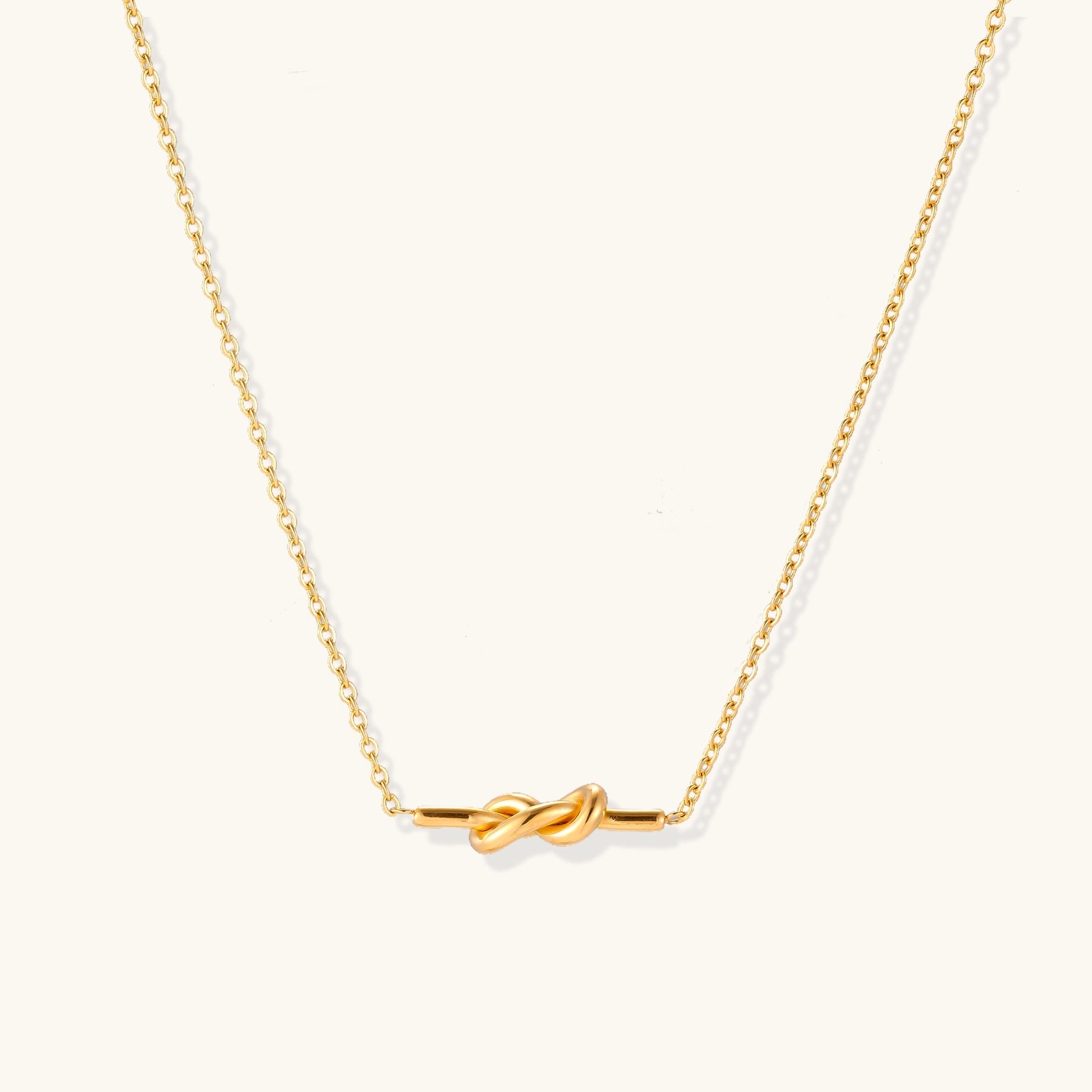 Dainty 18K gold plated necklace with infinity knot pendant on delicate chain against white background,  a perfect envouragement jewelry gift for women 