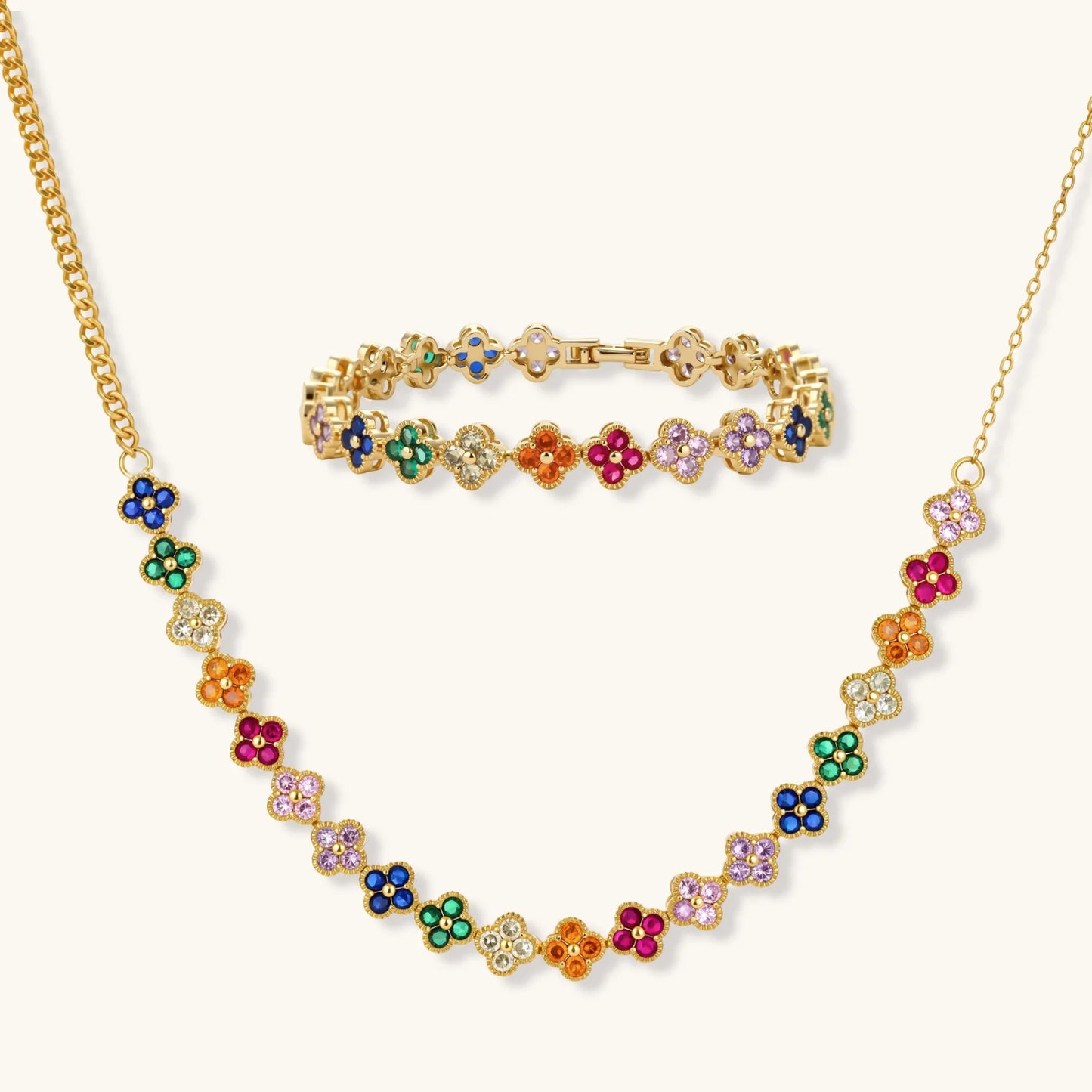 Colorful four-leaf clover jewelry set with rainbow cubic zirconia stones in gold-plated setting on white background, a perfect encouragement jewelry gift for women