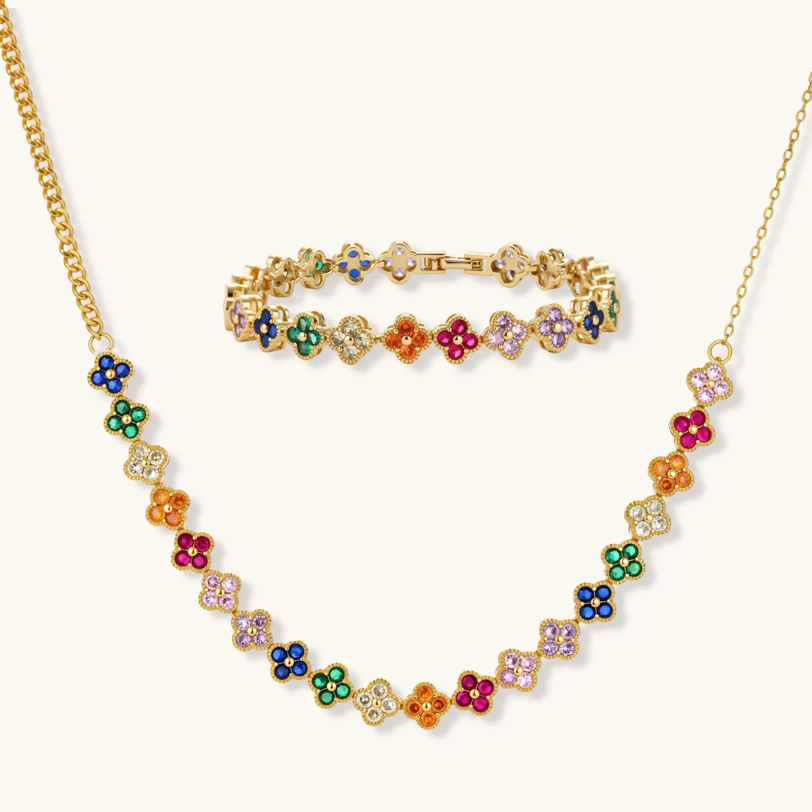 Colorful four-leaf clover jewelry set with rainbow cubic zirconia stones in gold-plated setting on white background, a perfect encouragement jewelry gift for women