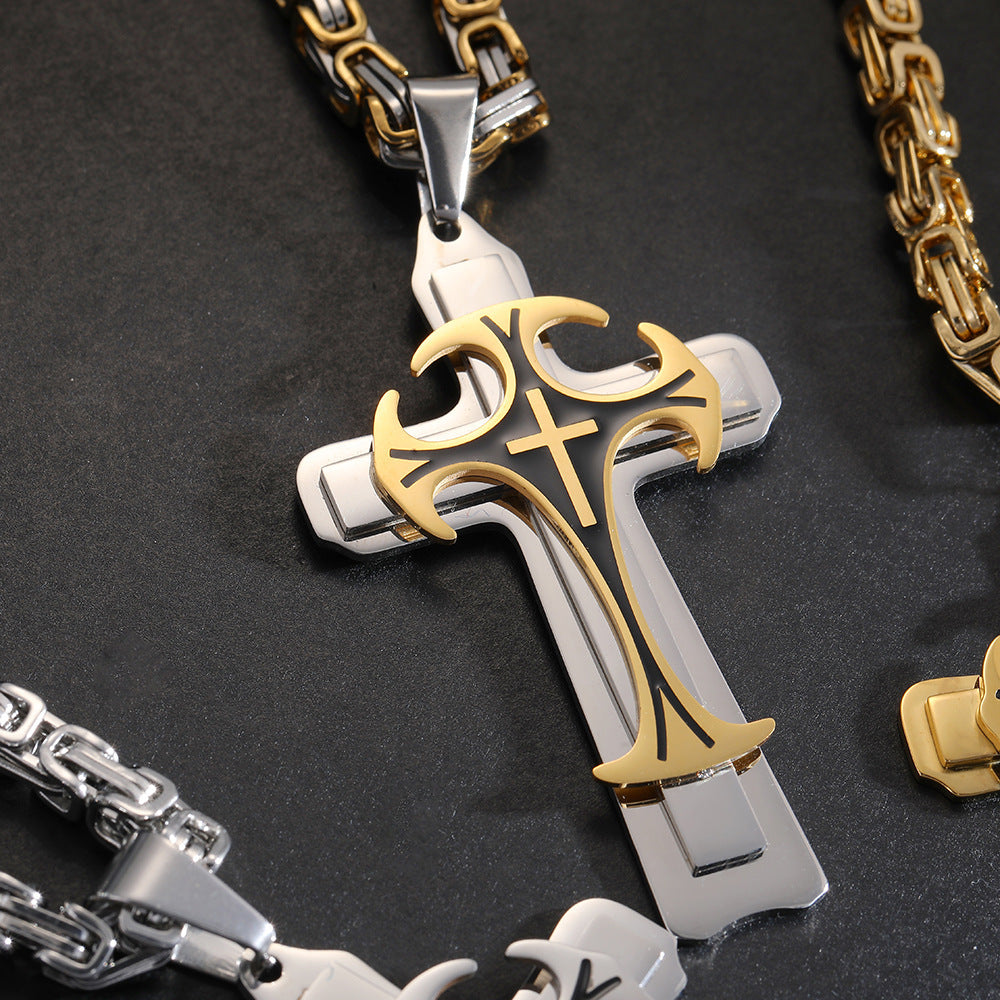 Gold and silver cross pendant on a dark background