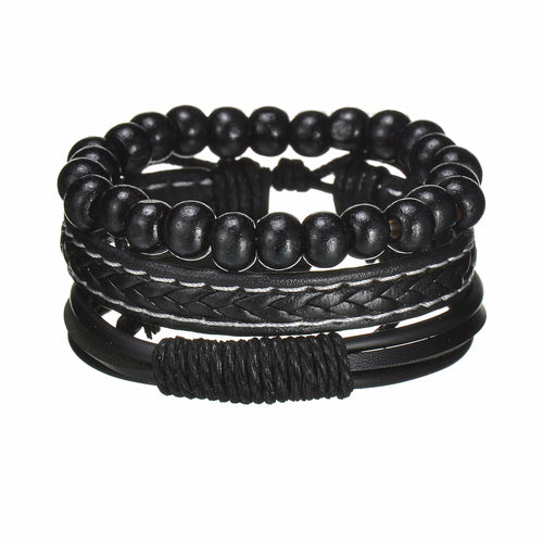 Stack of black beaded and braided bracelets on a white background