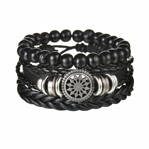 Black beaded bracelet with braided design and silver circular emblem on a white background