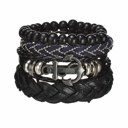 Stack of black beaded and braided leather bracelets with an anchor charm on a white background