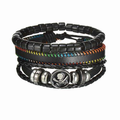 Stack of black leather bracelets with skull and crossbones charm on a white background