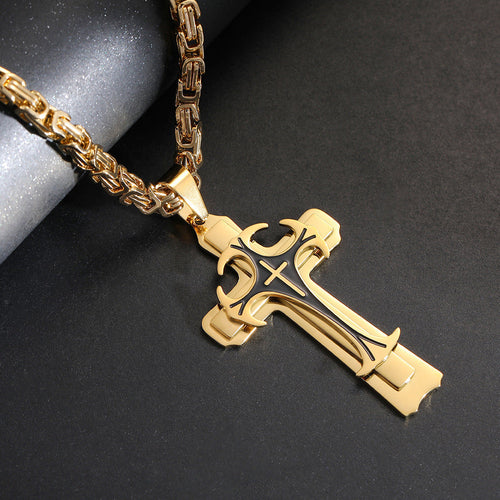Gold cross pendant necklace on a dark surface