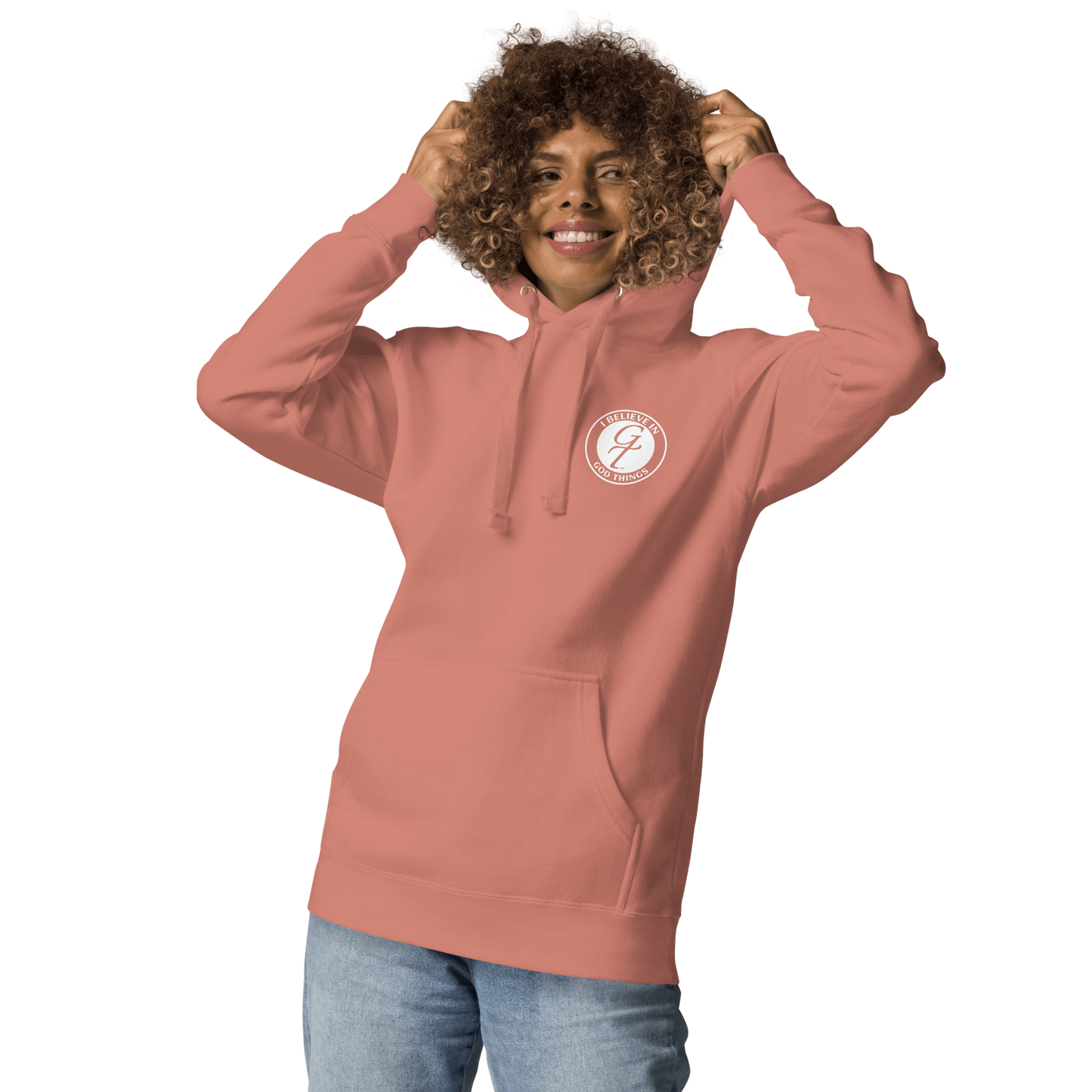 Christian faith hoodie model wearing a pink hoodie with 'I Believe In God Things' logo, promoting faith and comfort.