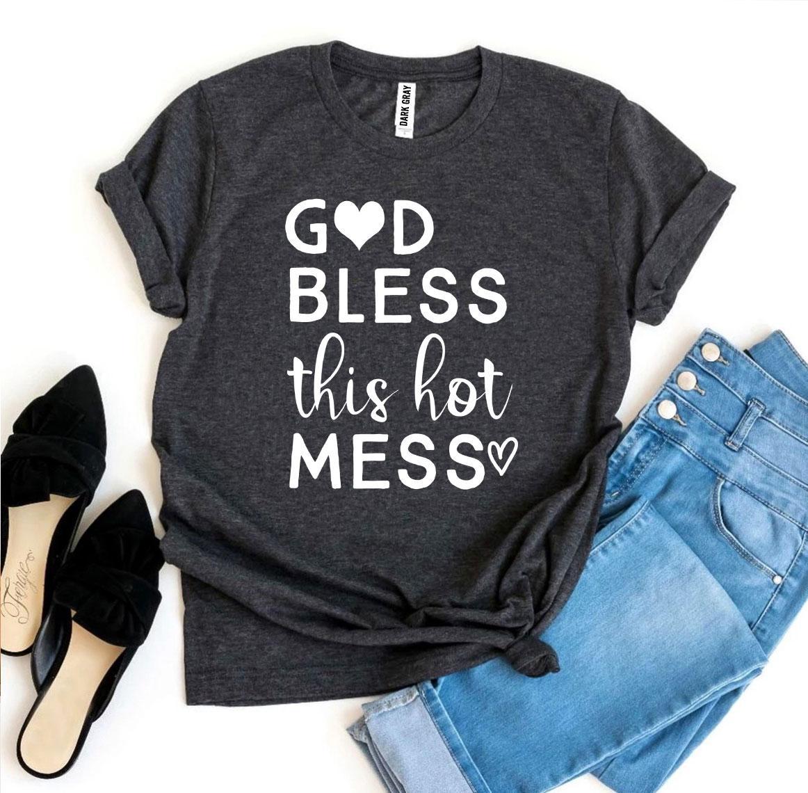 Dark gray t-shirt with 'God bless this hot mess' text, paired with jeans and shoes on a white background